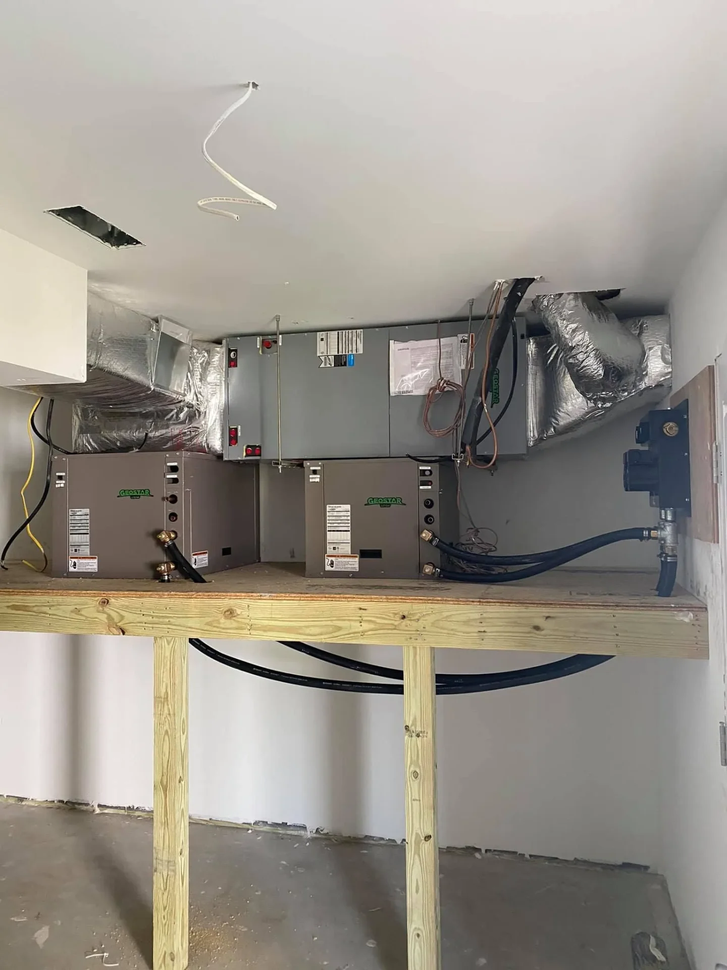 Dual geothermal heat pump units with ductwork
