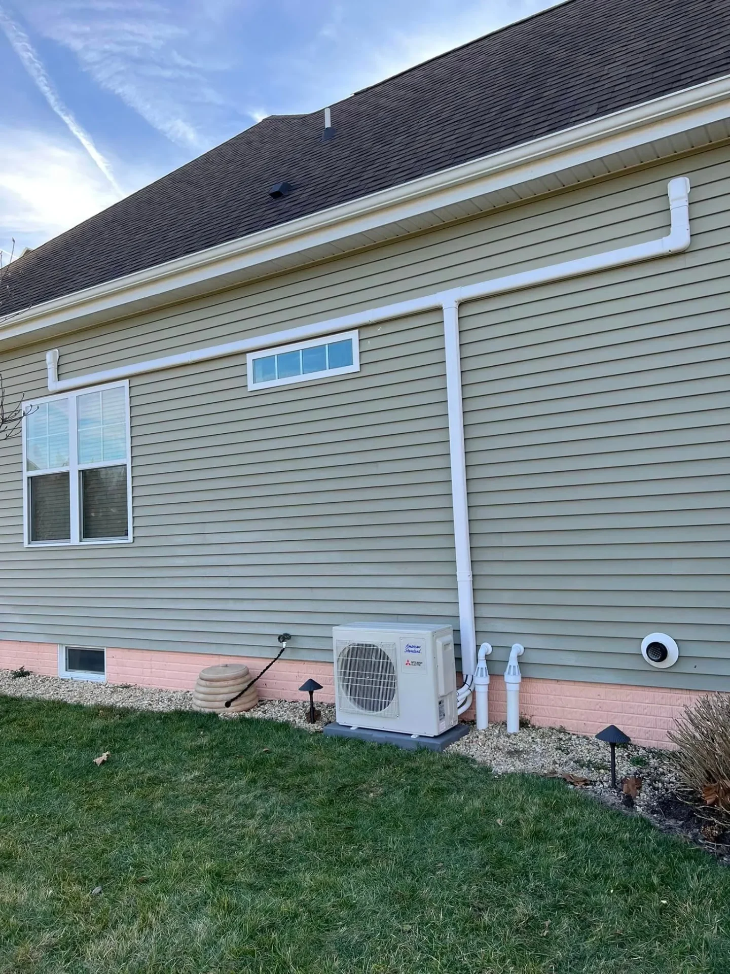 Mitsubishi mini-split condenser on concrete pad